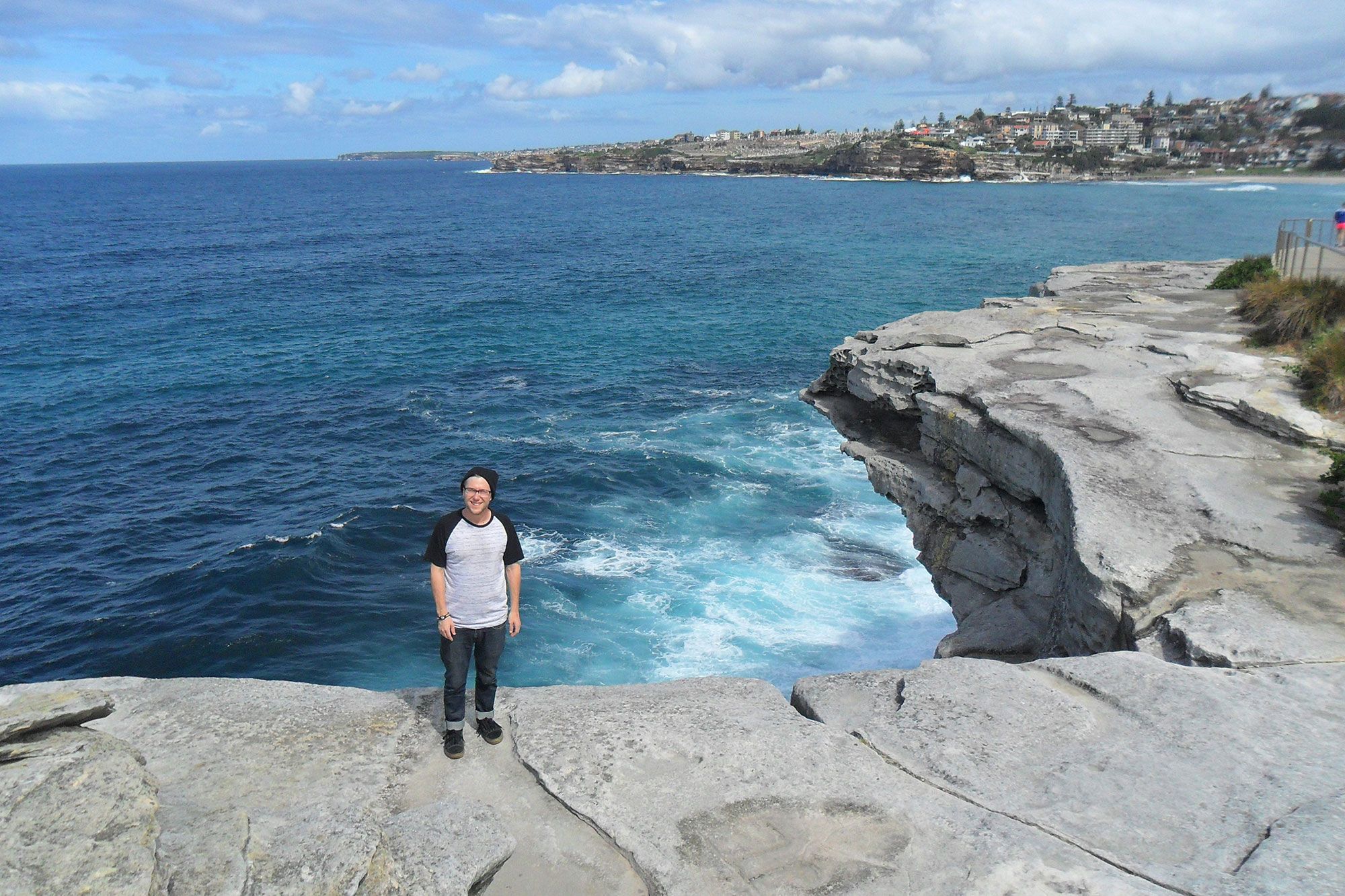 B. Youngz standing at Bondi Beach in Australia